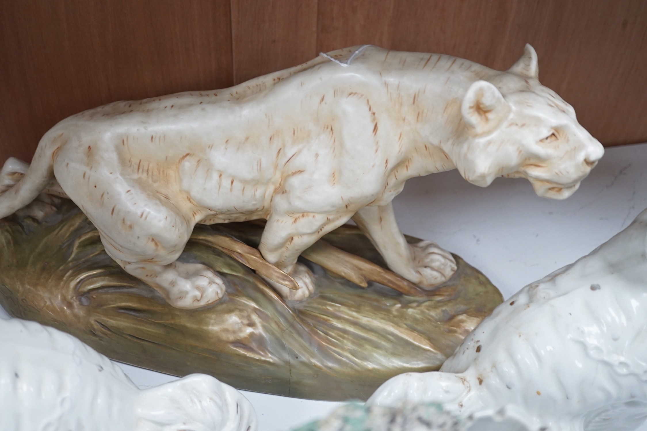 A Royal Dux tiger, a pair of Staffordshire Spaniels and a figural flat back, tiger 48 cms high